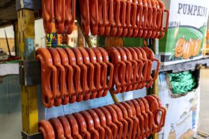 Canyon Rigging Equipment displayed on a Canyon Rigging product rack. This rack is filled with foundry hooks. the hooks are orange.