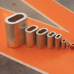Canyon Rigging products displayed on feature table. in this photo there are eight aluminum and copper sleeves showing a range of rigging hardware and components.