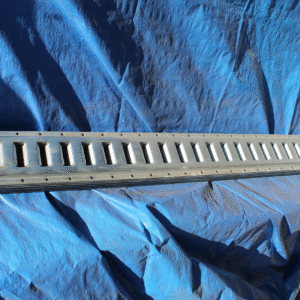 Product photo of E-track. The E-track is on top of a trap. The track is showing polished metal.