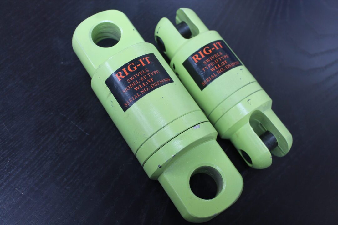 Canyon Rigging Angular Bearing Swivel product photo. The product is displayed on a black surface. The angular bearing swivel is a green colour and includes two products.