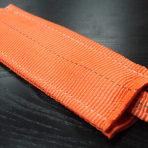 Canyon Rigging Sliding Wear Pad product photo. the Sliding wear pad is orange and attached to a one inch round sling.