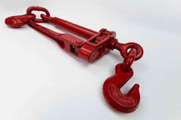Product photo of Canyon Rigging's Folding handle ratchet boomers, ratchet load binders, on an angle. the background is white and the load binder is coloured red. the hook is at the front and the photo displayed a forced perspective.