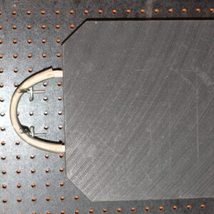 Canyon rigging product photo of outrigger pad. the photo has a plastic outrigger pad displayed on a black product wall. The pad has a handle and is black.