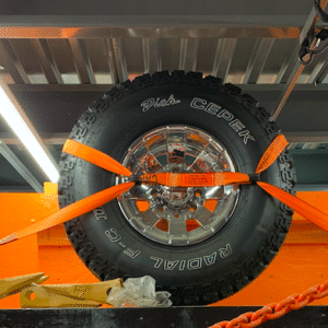 product photo of Wheel/Tire Tiedown Kits in use. The straps are used to keep a tire secure while being transported.