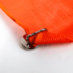 Canyon Rigging Flag magnet product photo. in this photo there is a magnet that is clipped to a mesh flag. the corner is rolled up to show its texture.
