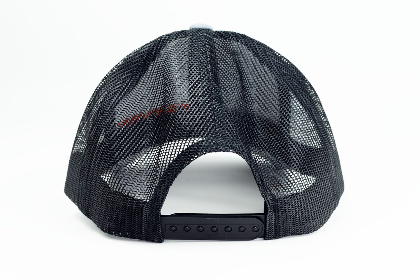 Canyon Rigging product photos of our rigging snap back cap. The hat is a grey with Canyon Rigging's logo on it. the back of the hat is mesh with a snap size adjuster. This is a photo of the back of the hat.